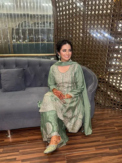 A beautiful client ready for a Mehndi ceremony. Her makeup is elegant and understated, with a classic updo to keep the focus on her traditional outfit.