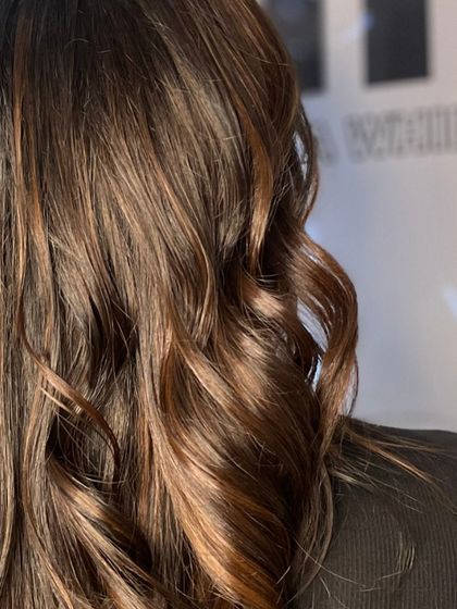 A close-up on the texture and shine of these effortless waves, capturing the healthy look of the hair.