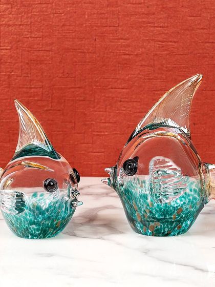 This pair of handblown glass fish features a beautiful mix of red and teal colors. They make a wonderful decorative accent, bringing a touch of the ocean's beauty indoors.