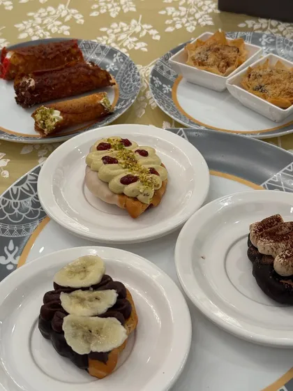 A beautiful spread of our desserts, including cannolis, and various cream topped croissants. A feast for the eyes and the palate.