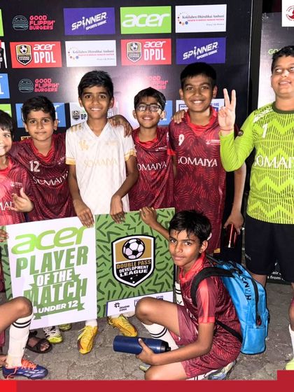 The U-12 team celebrates with their Man of the Match winner, Dhyan Mavani, after a successful day of competition.
