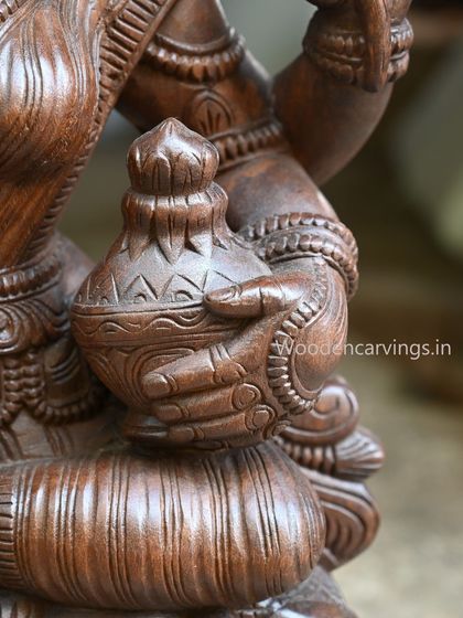 A detail of the hand holding the lower money pot on the 36-inch MahaLakshmi statue.