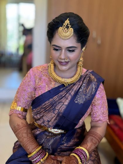 Gowthami looking stunning for her son's naming ceremony. The makeup is traditional, with a focus on flawless skin and defined eyes.