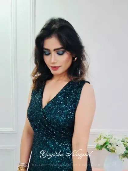 A still image of the green smokey eye look, showing how it complements her sequined dress perfectly.