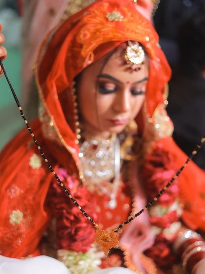The significant moment of the Mangalsutra ceremony, captured up close to show the emotion and detail.