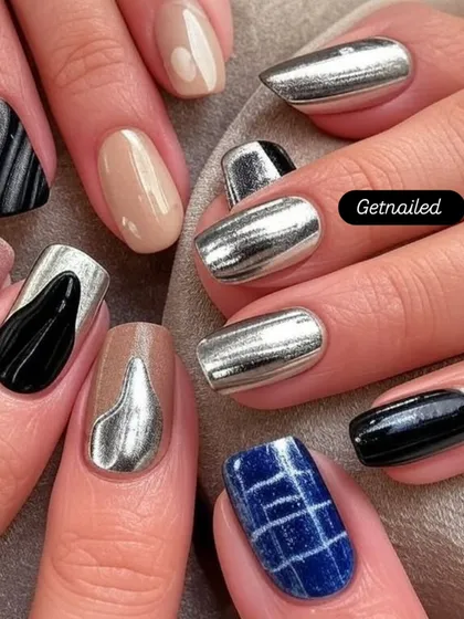 This set showcases a variety of chrome and metallic designs on each nail. From solid silver chrome to abstract black and silver patterns, it's a great example of a customized, edgy look.