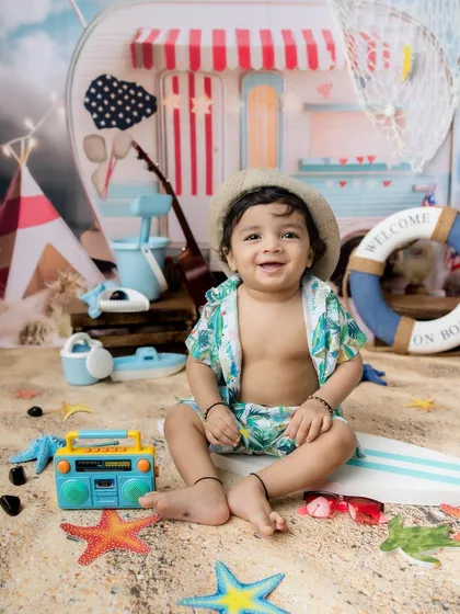 This little dude is ready to hit the waves. The beach-themed photoshoot is great for boys and girls.