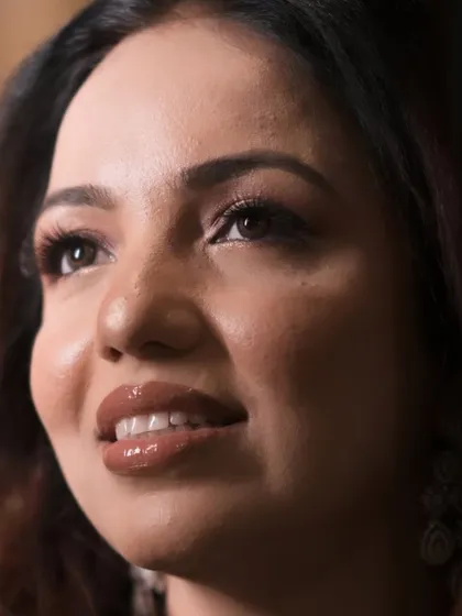 An artistic close-up capturing the glossy lips and glowing skin of this beautiful engagement makeup look.