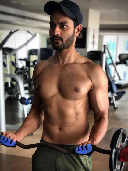 Staying strong and active is a lifestyle. A shot from one of my own gym sessions, focusing on bicep curls with an EZ bar to maintain physique and strength.