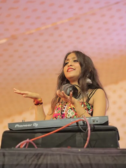 A colorful shot of me interacting with the crowd during a dandiya night. My traditional-style top and jhumkas were perfect for the occasion.