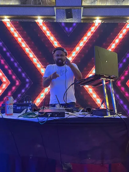 Pointing to the dancers on the floor, feeling the energy of the room. A great DJ reads the crowd and responds with the perfect track to keep the party going.