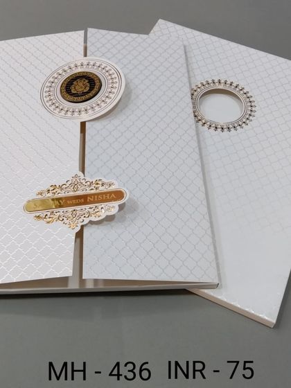 This modern white invitation has a textured pattern and a gate-fold opening. The gold emblems add a touch of elegance to the minimalist design.