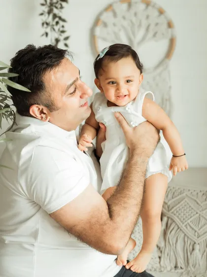 Sometimes, the simplest moments are the most powerful. This sweet father-daughter portrait from a studio session focuses on their connection, creating a timeless and classic family photograph.