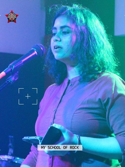 A poet sharing her verses with the audience. Spoken word is a vital part of our open mic, offering a platform for powerful voices.