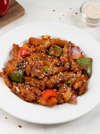 A plate of crispy chili potato, a popular Indo-Chinese dish. We ensure that fried foods look crispy and delicious, never greasy.