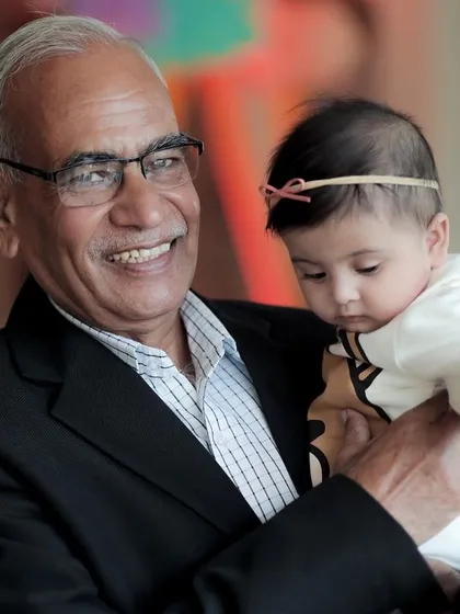 A tender moment between a grandfather and his baby granddaughter during a family celebration. I believe in capturing the love that flows through all generations, creating timeless memories for your family to cherish.
