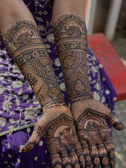 The full view of the arms, showcasing a story that unfolds from the palms to the elbows, filled with personal and traditional Indian art.