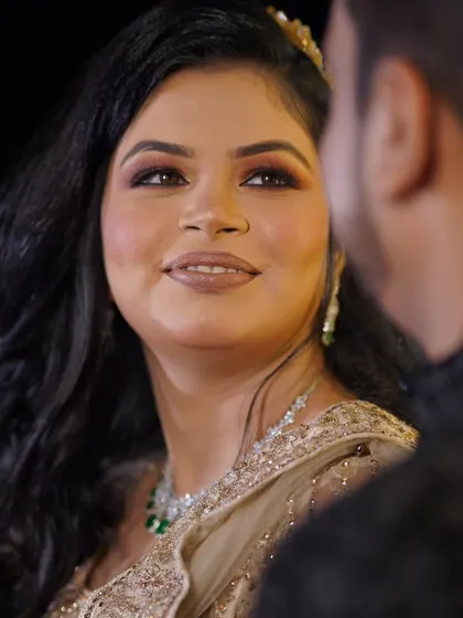 A close-up, candid moment during a conversation. The bride's soft smile as she looks at her partner is a beautiful, unposed memory.
