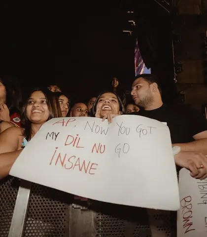 The fans are the heart of every show. I love seeing the passion and creativity from the crowd, like this fan's sign for AP Dhillon that captures the wild vibe of the night.