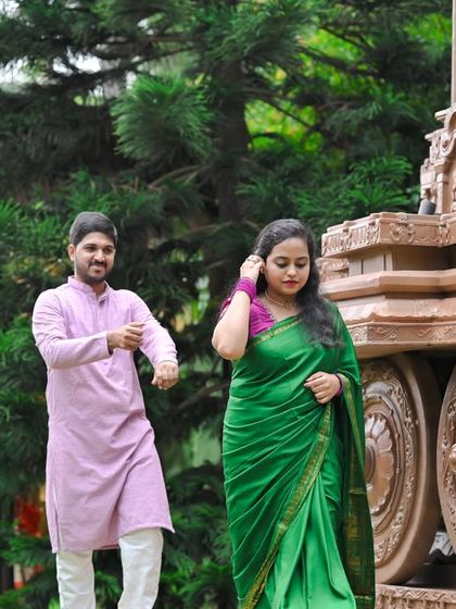A candid moment of a couple dancing by our replica of the Hampi stone chariot, a unique and culturally rich backdrop.