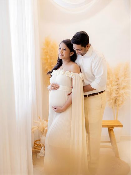 Looking towards their future together. This portrait captures the shared dreams and excitement of the expecting couple in a beautifully lit studio setting.