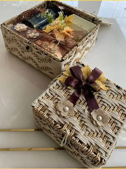 Our jute hamper in a fresh beige and gold color. This open box shows the thoughtful arrangement of chocolates and other treats inside, perfect for any occasion.