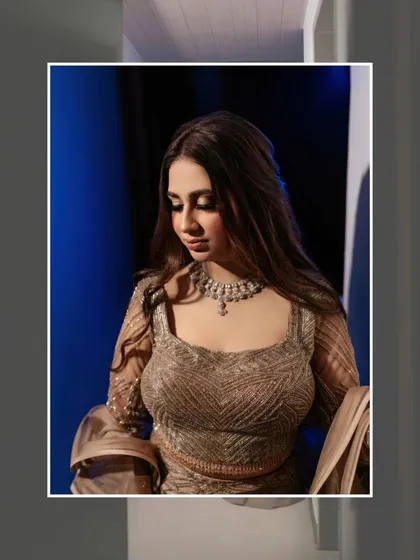 A close-up portrait of Nisha, her expression serene, framed to emphasize her beauty and the stylish cut of her gown.