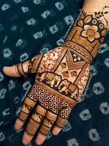 A traditional back-of-hand design featuring a procession of elephants. The design also includes swans on the fingers and a floral motif on the wrist.