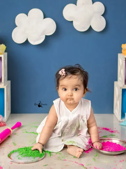 A curious little one explores the different colored powders. These sensory experiences make for wonderful expressions and authentic moments.