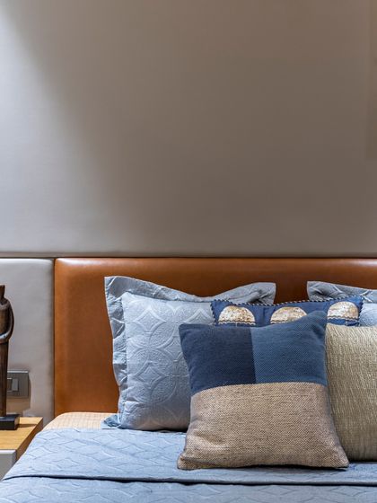 A close-up on the bedding in the Filigree House, showcasing the mix of patterns and textures in shades of blue. These details add depth and character to the serene space.