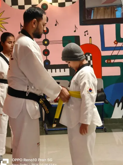 A student receives his yellow belt. Each belt promotion is a moment of pride and a motivator to keep training hard.