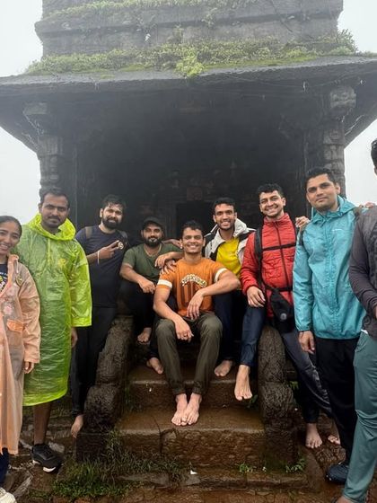 Another group posing on the steps of the Sarvajna Peetha at Kodachadri. The raincoats show it's a true monsoon adventure.
