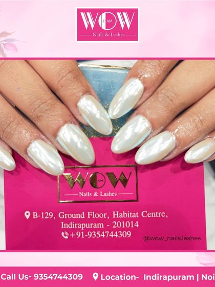 These elegant almond-shaped nails feature a pearly white chrome finish. This look is incredibly chic and reflects the light beautifully for a high-shine, ethereal effect.