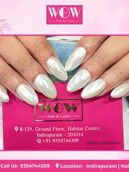 These elegant almond-shaped nails feature a pearly white chrome finish. This look is incredibly chic and reflects the light beautifully for a high-shine, ethereal effect.