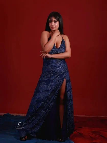 A simple, elegant standing pose. Her hand gesture adds a touch of softness to the powerful look.