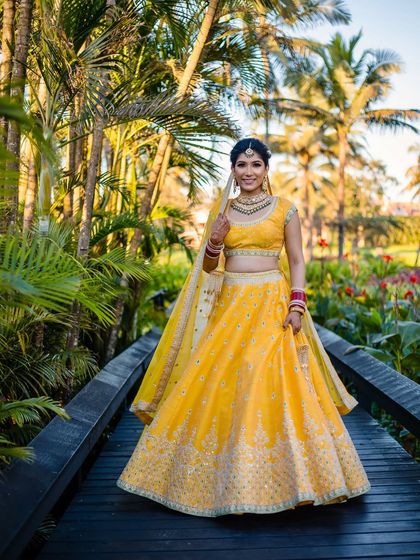 This bride is a vision in yellow. The makeup is kept light and airy to match the daytime destination wedding, with a focus on flawless skin and bright, happy eyes.