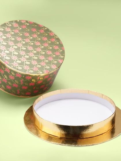 A round, patterned gift box, shot open to show its shape and depth. Our catalogue photography clearly communicates the product's form and function.
