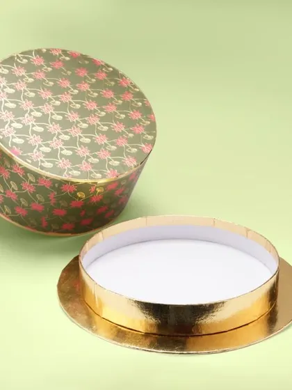 A round, patterned gift box, shot open to show its shape and depth. Our catalogue photography clearly communicates the product's form and function.