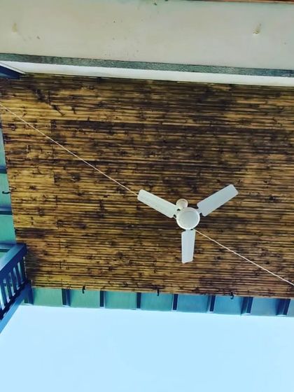 A close-up of the burnt-finish bamboo ceiling, adding a rustic and natural texture to the modern pergola structure.