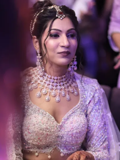 A close-up of the Cannes-inspired look. The makeup is elegant and radiant, with a focus on flawless skin and sparkling eyes.