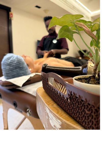 Creating a peaceful atmosphere is part of the service. Here you can see our therapist setting up for a session, ensuring your space becomes a haven for healing.