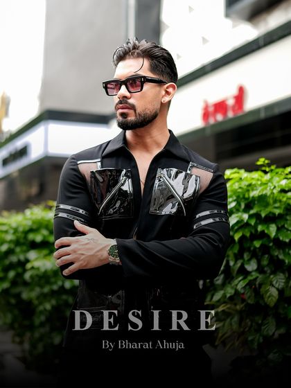 Bold, edgy, and unapologetically modern. This shirt redefines luxury menswear with its striking cuts and high-gloss detailing.