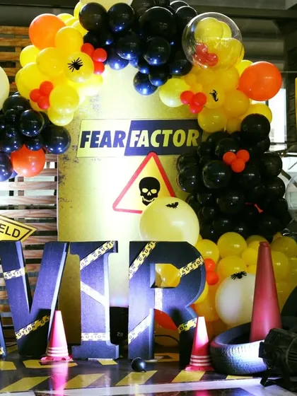 A thrilling Fear Factor theme for a 9th birthday. The decor uses caution tape, hazard signs, and a black and yellow color scheme to create a daring and adventurous atmosphere.