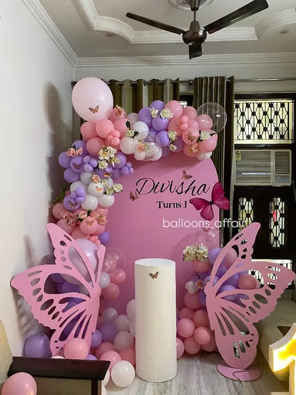 Another angle of the butterfly-themed first birthday, showing the full setup in a home environment.