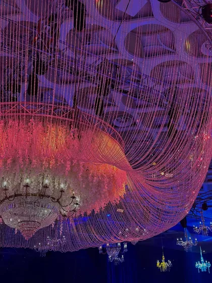 A dazzling cascade of crystals and blooms. This close-up of a ceiling installation shows how we layer light, texture, and color to create a sense of grandeur and glow. 💫
