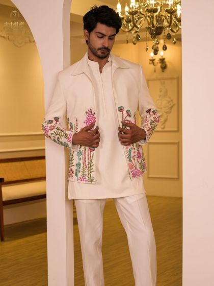 Our ivory floral embroidered jacket paired with a matching kurta and trousers. This full-length view shows the outfit's clean lines and modern silhouette, perfect for a sophisticated daytime wedding event.