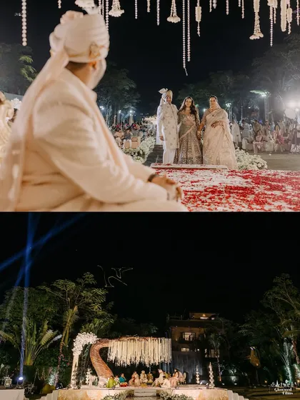 A wide-angle view of a night wedding at Della Resorts. The mandap is lit to perfection, creating a stunning contrast against the dark sky and surrounding trees.
