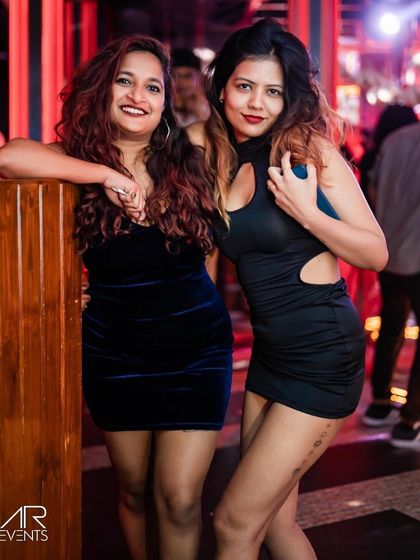 Two ladies dressed up and ready to party at The Fixx Bar. It's a place to see and be seen.