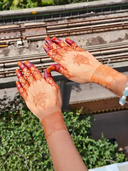 Holding up the beautifully stained hands against the sky.