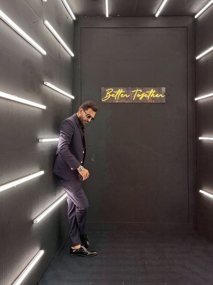 A stylish pose in a modern, well-lit corridor. My style is contemporary and sharp, ensuring I look professional and fit the aesthetic of any high-end corporate function.